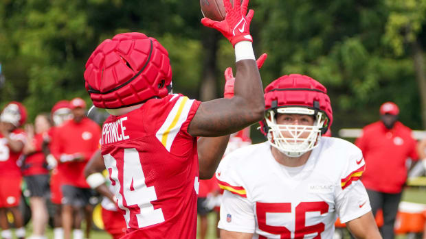 Jul 24, 2023; St. Joseph, MO, USA; Kansas City Chiefs running back Deneric Prince (34) catches a pass as defensive end George Karlaftis (56) defends during training camp at Missouri Western State University. Mandatory Credit: Denny Medley-USA TODAY Sports